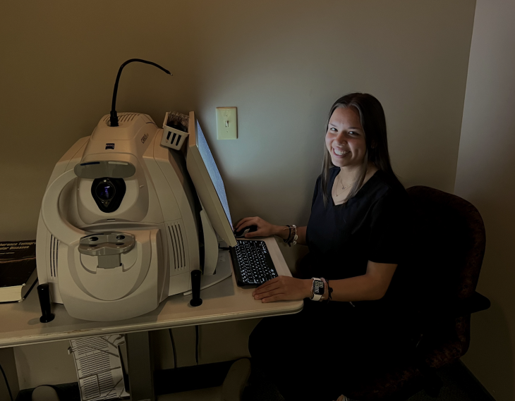Cortes sits at an eye examination computer working at her Alamance Eye Center internship